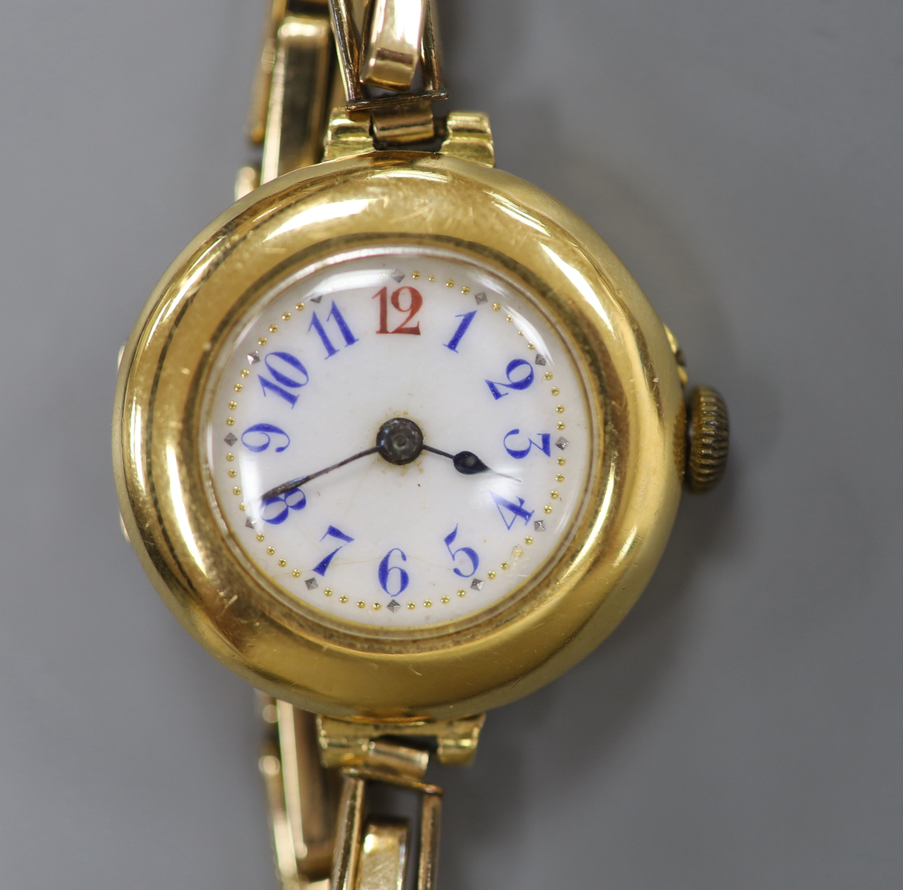 A ladys early 20th century continental 18c yellow metal manual wind wrist watch on gold plated bracelet, gross 22.3 grams,